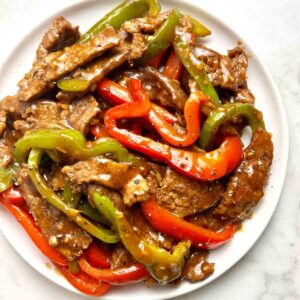overhead shot of pepper steak on plate.