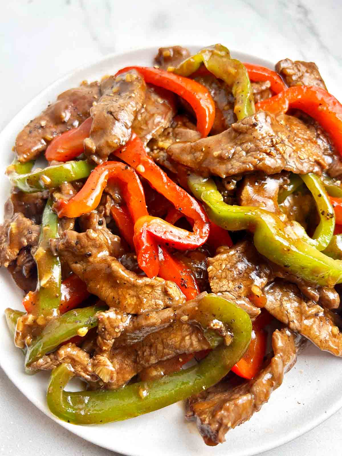 close up of pepper steak on plate.