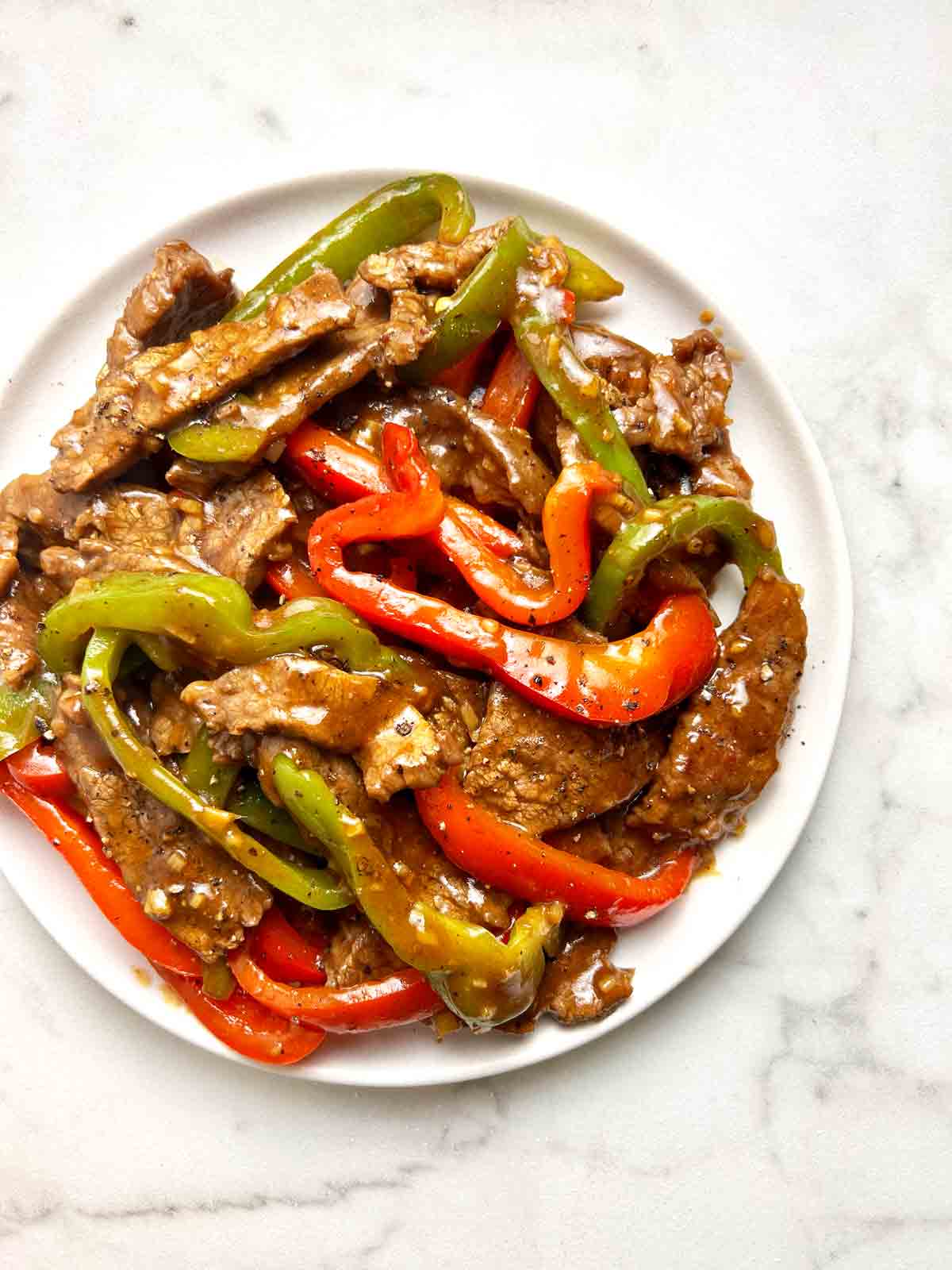 overhead shot of pepper steak on plate.