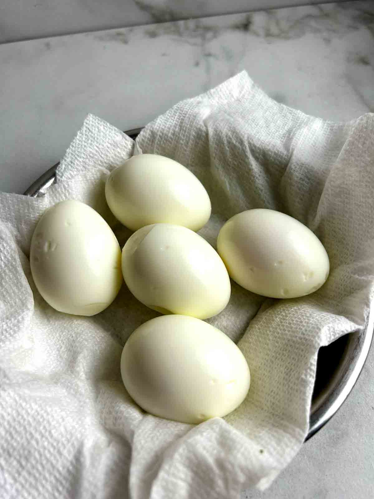hard boiled eggs drying on plate.