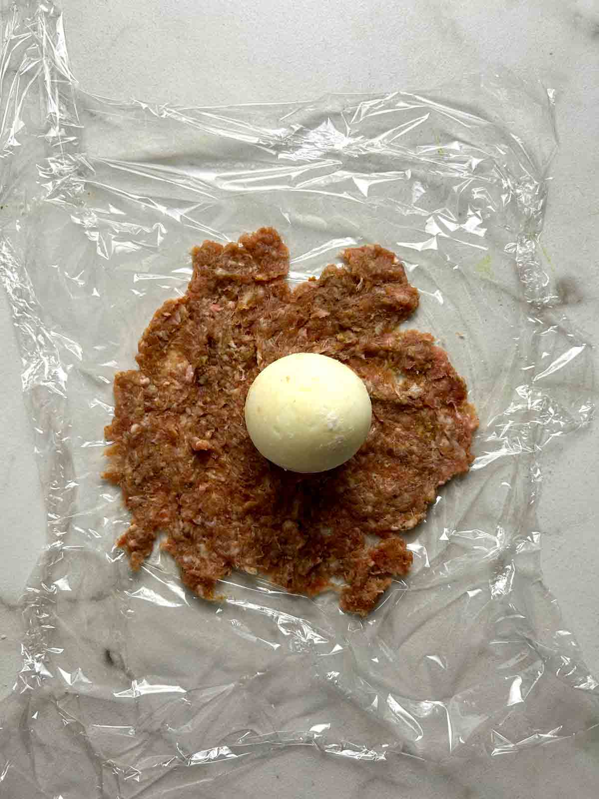 egg on top of flattened meat mixture.