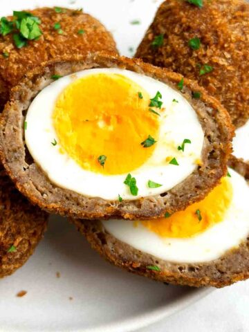 close up of scotch egg cut in half.