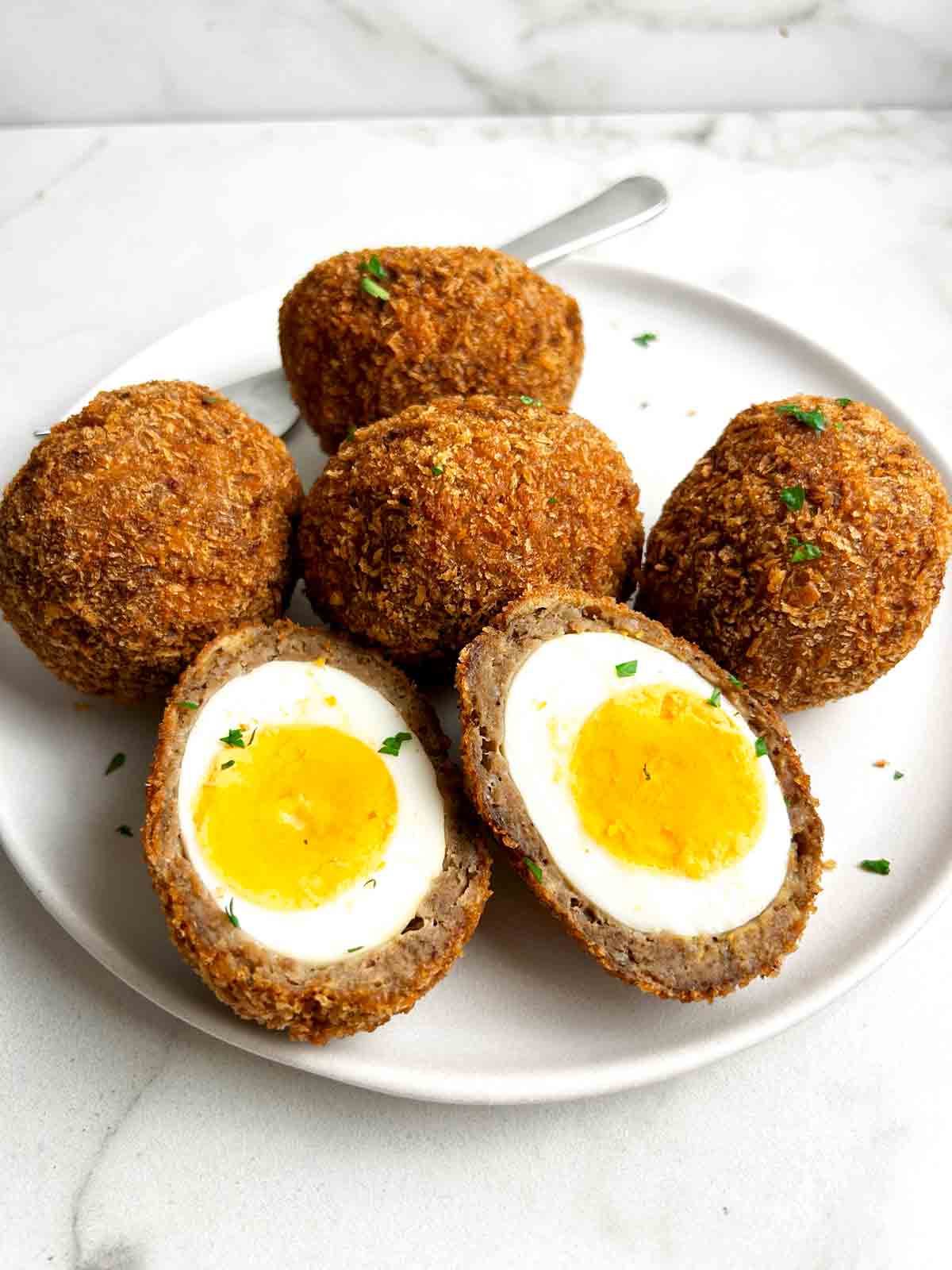 scotch eggs on plate.