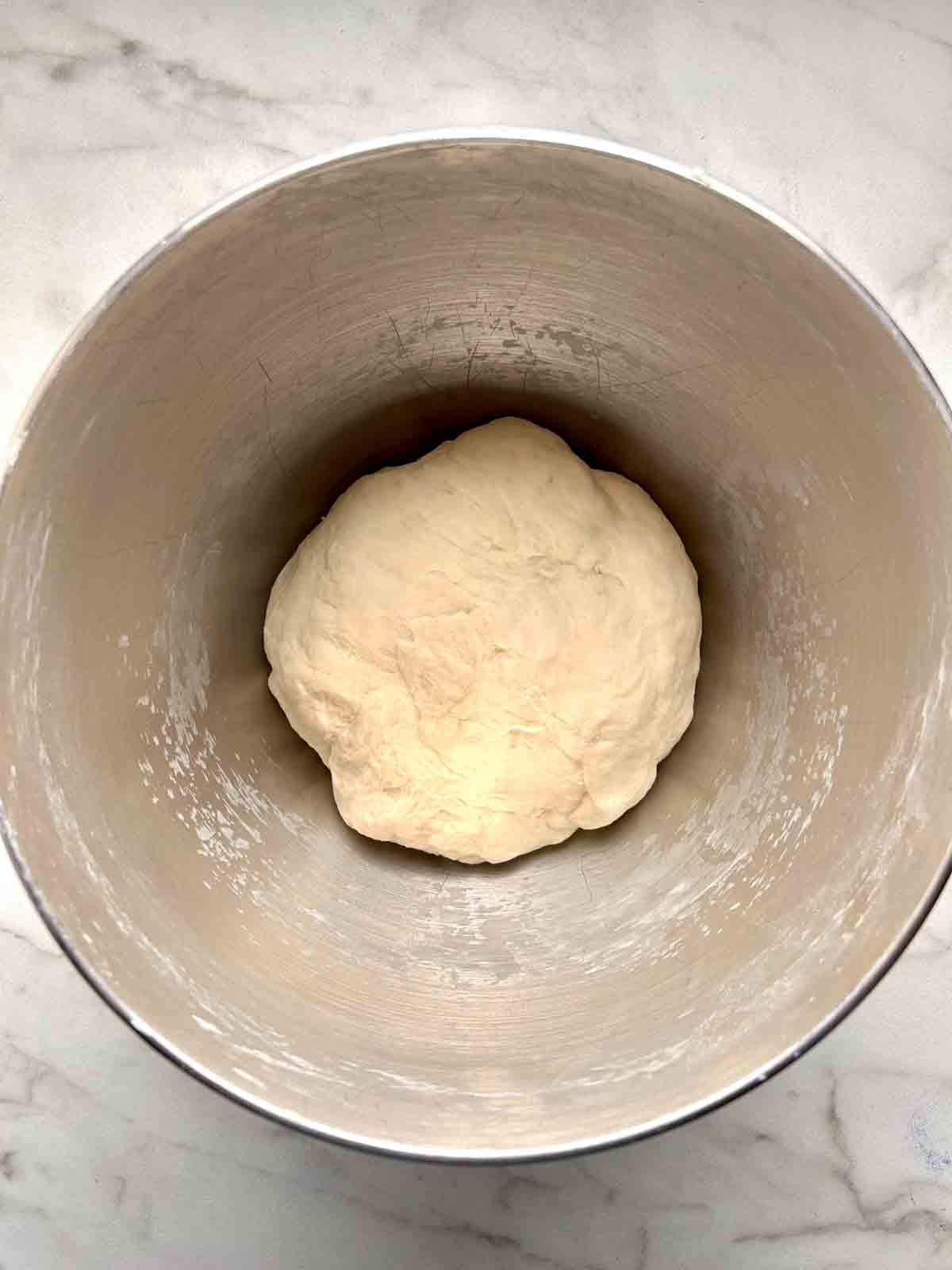 smooth, firm, non-sticky dough in stand mixer bowl.