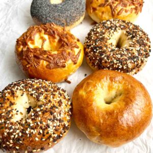 assorted sourdough bagels on parchment paper.