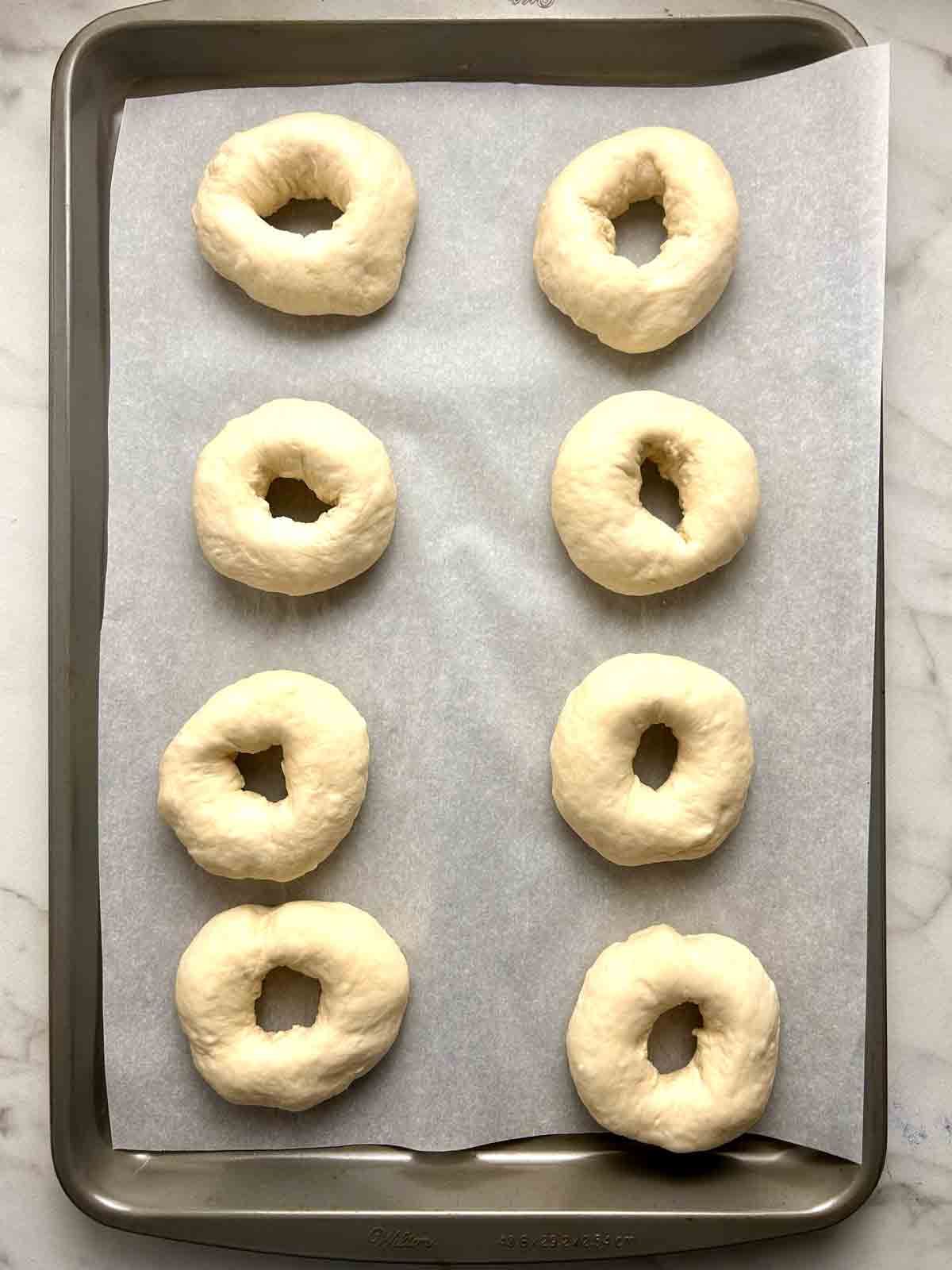 bagels shaped on baking sheet.