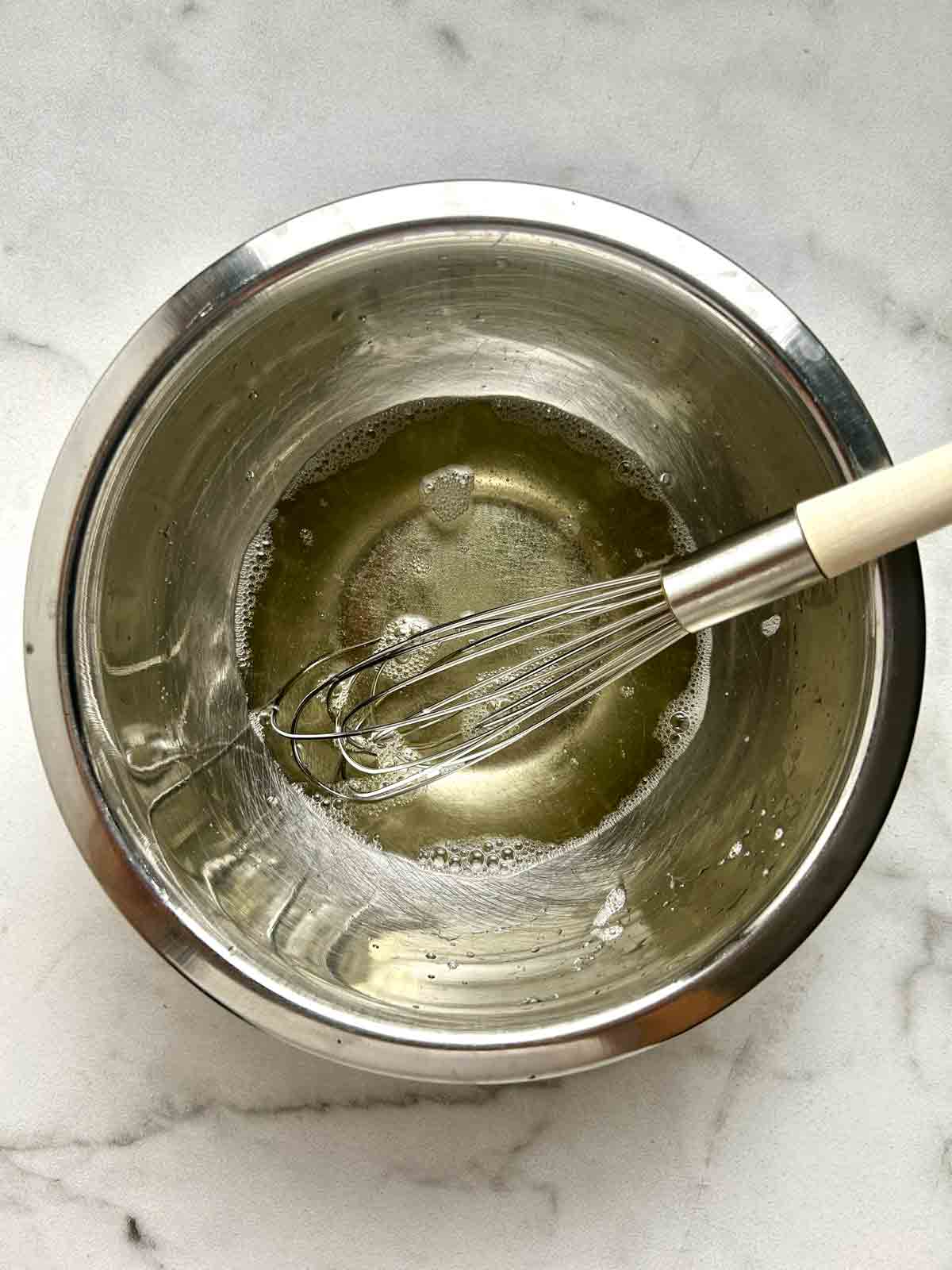 sugar and rice vinegar whisked in bowl.