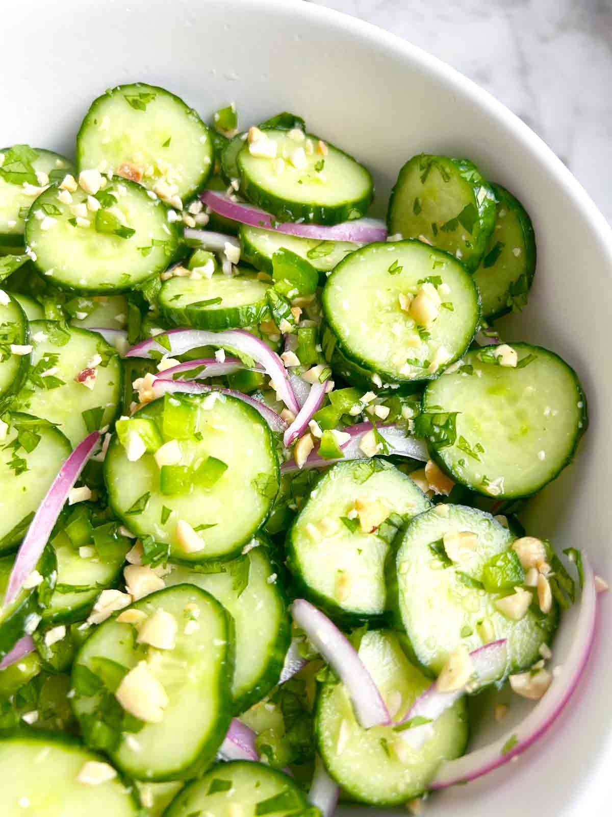 close up of Thai cucumber salad in bowl.