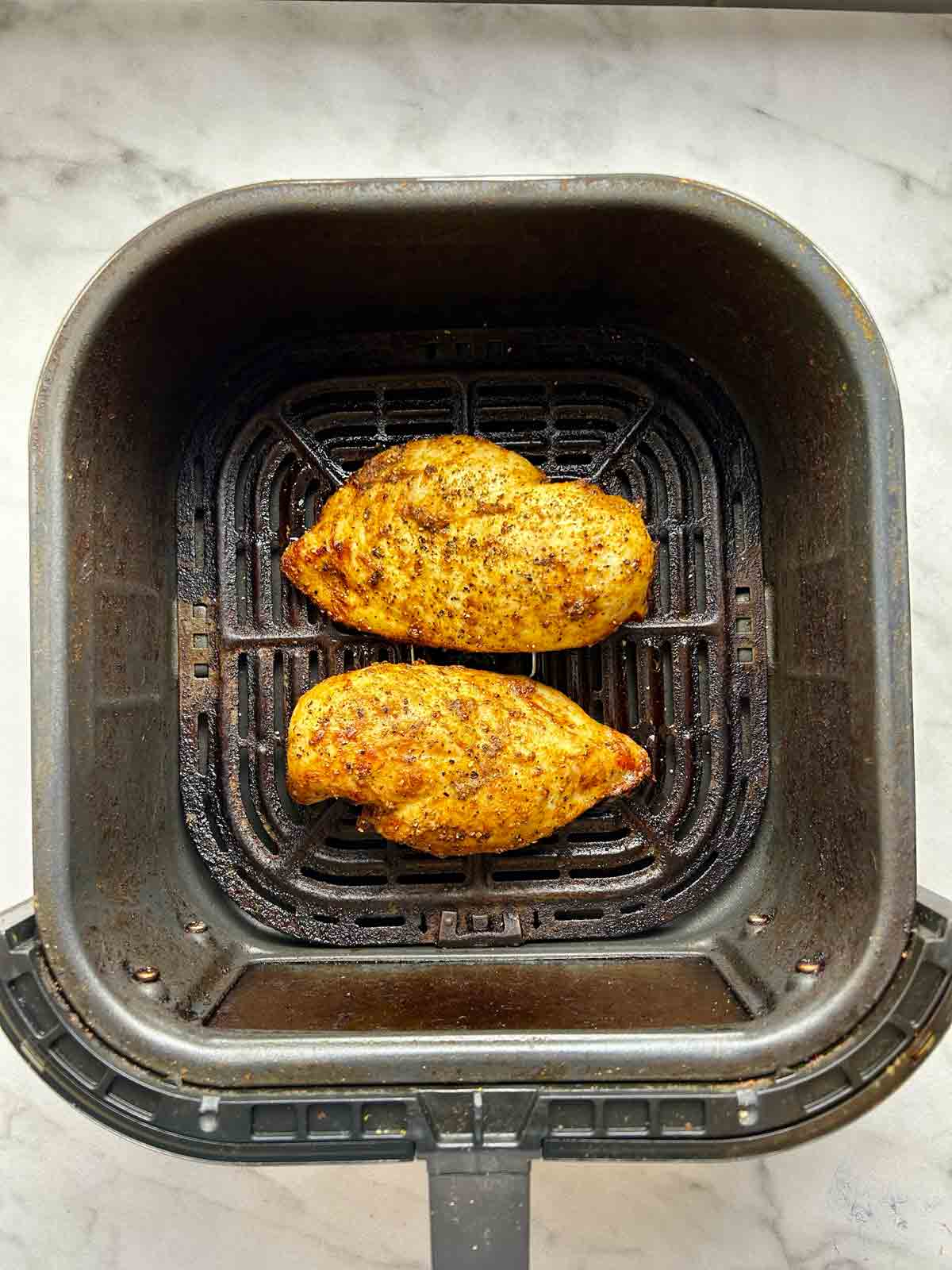 chicken breasts after being air-fried; golden brown on outside.