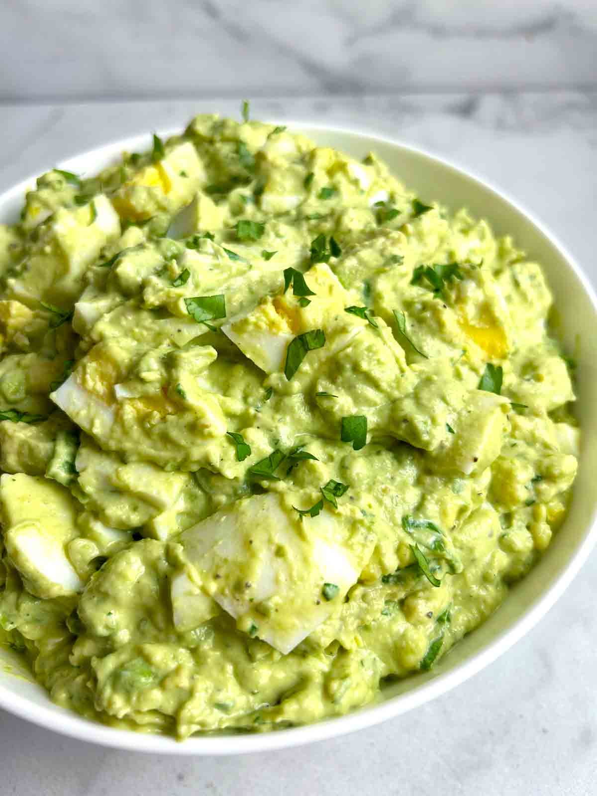 close up of avocado egg salad in bowl.