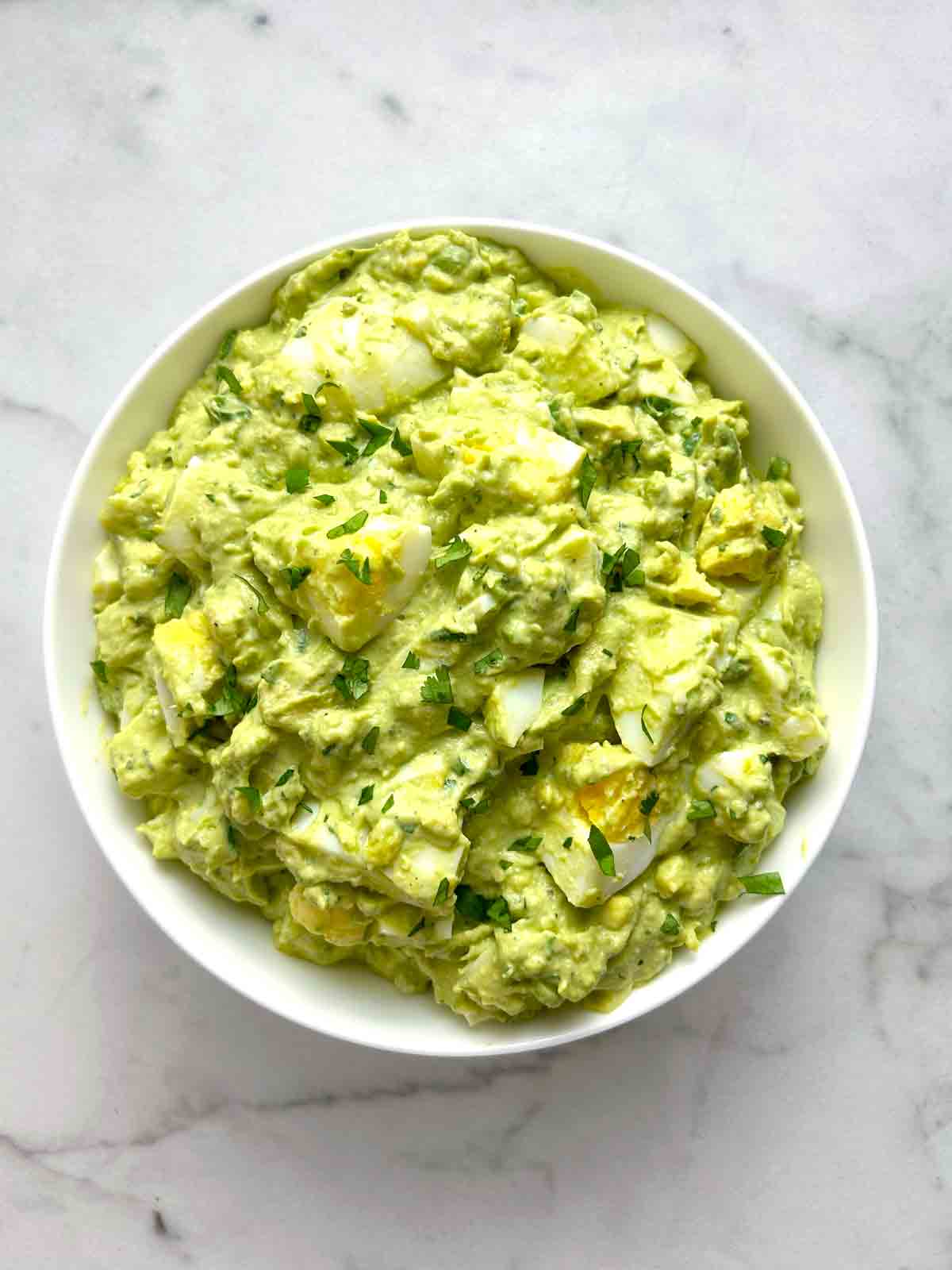 overhead shot of avocado egg salad in bowl.