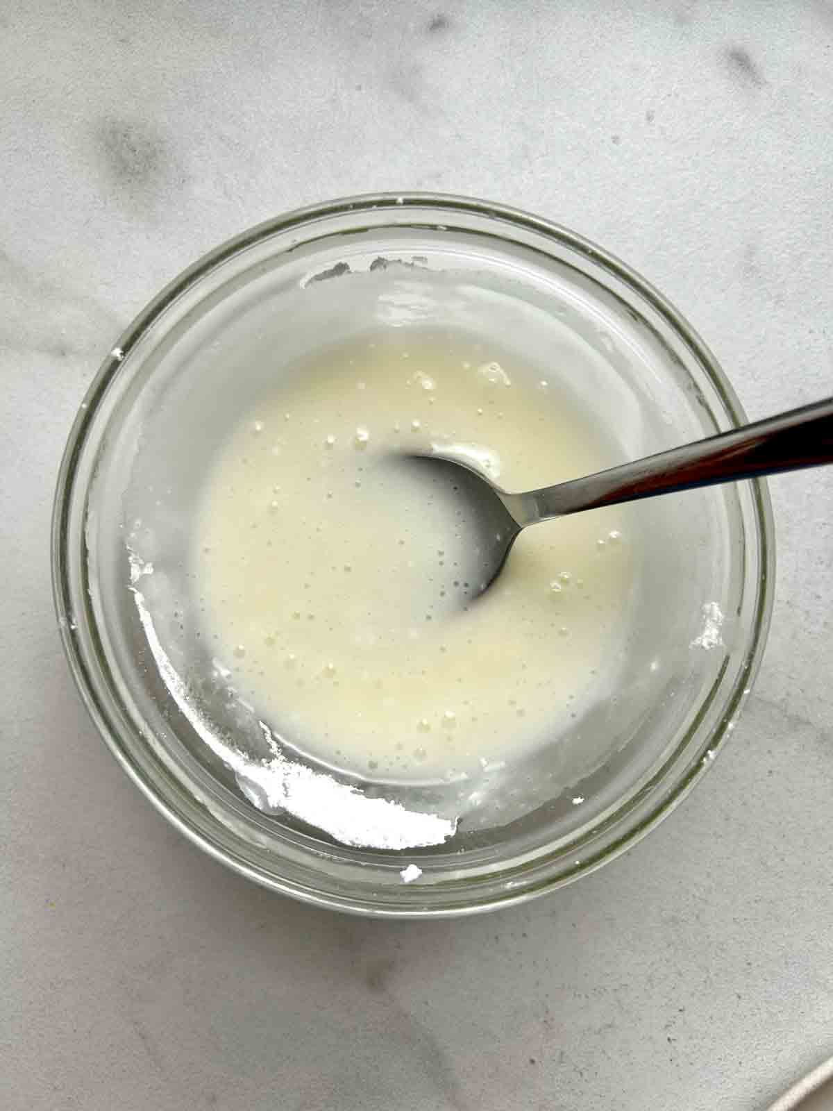 vanilla icing ingredients combined in small bowl.