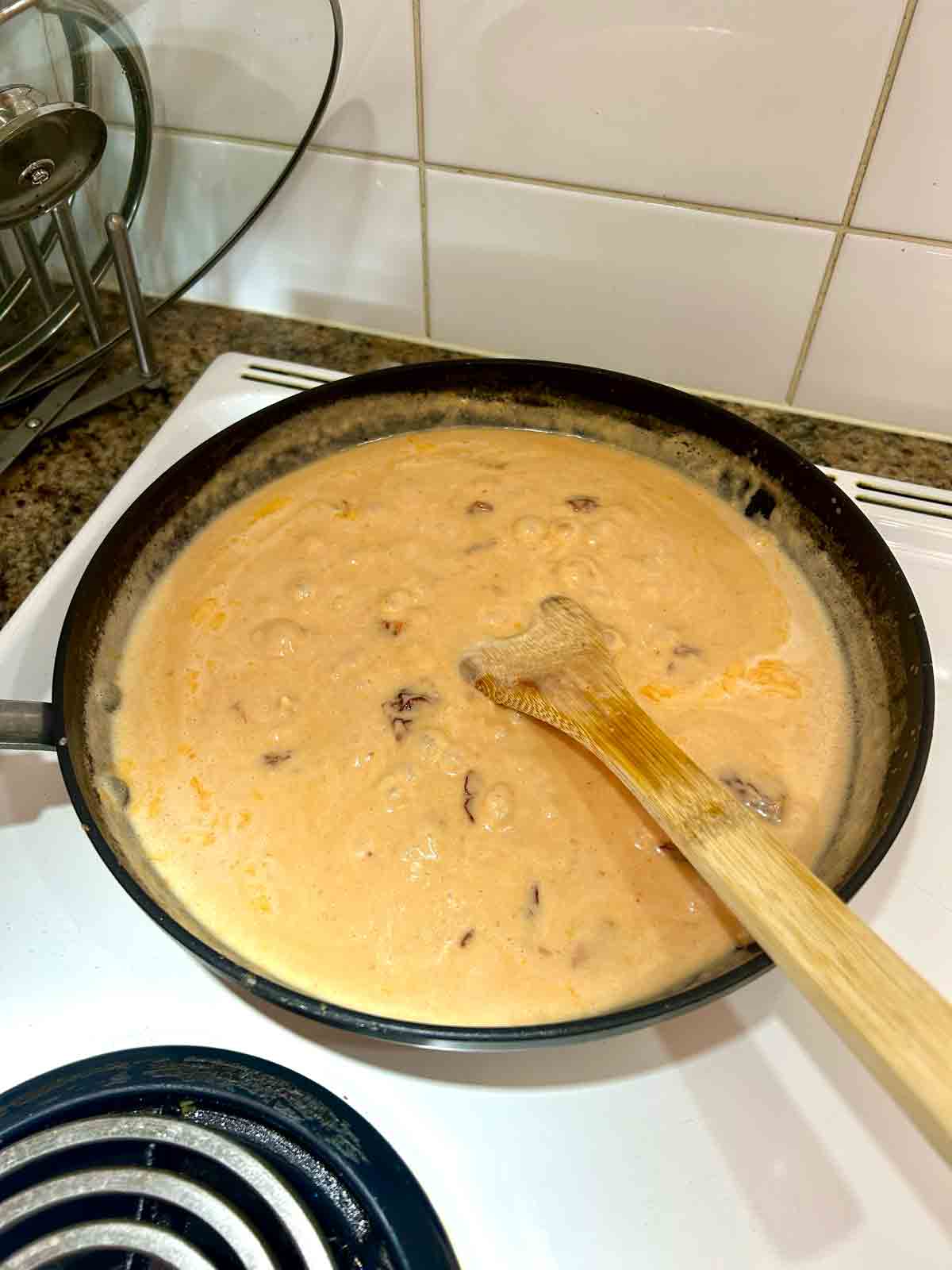 cream, broth, tomato paste, and sun-dried tomatoes added to sauce.