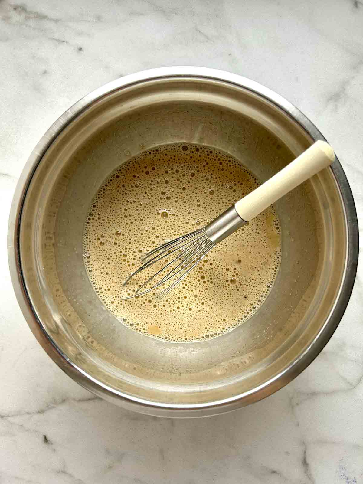 egg custard whisked in bowl.