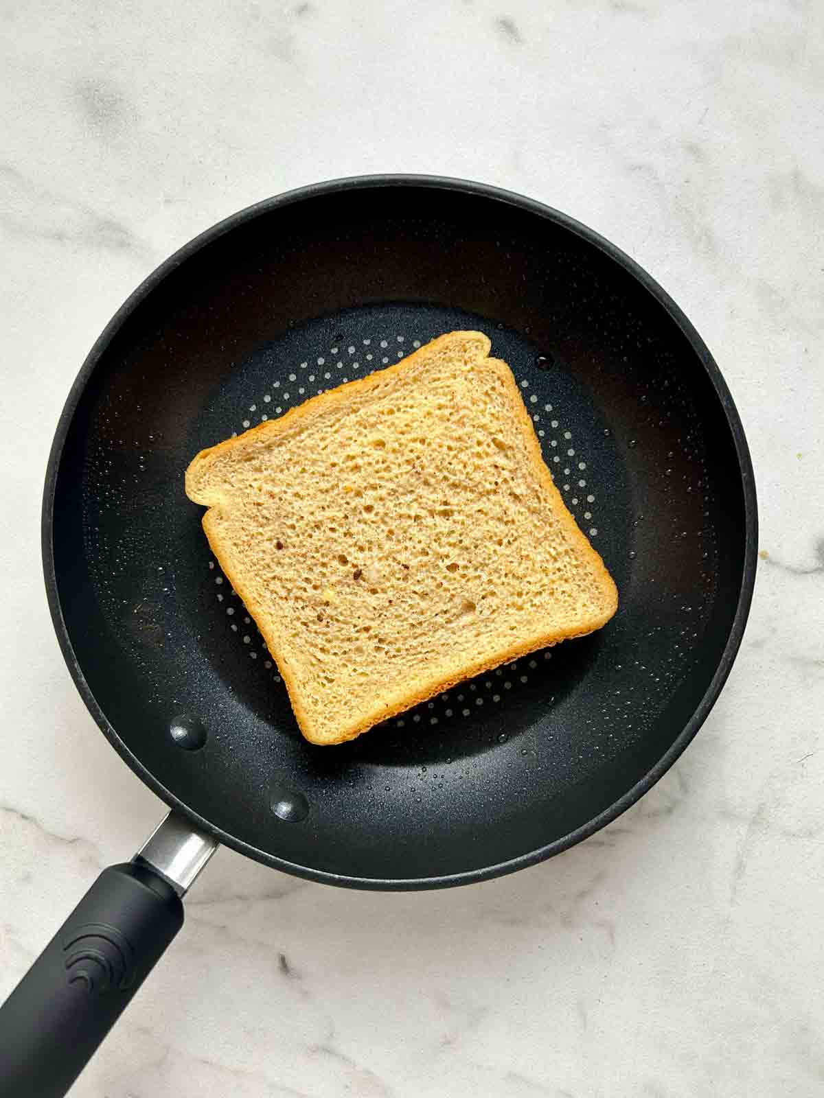 soaked bread frying on skillet.