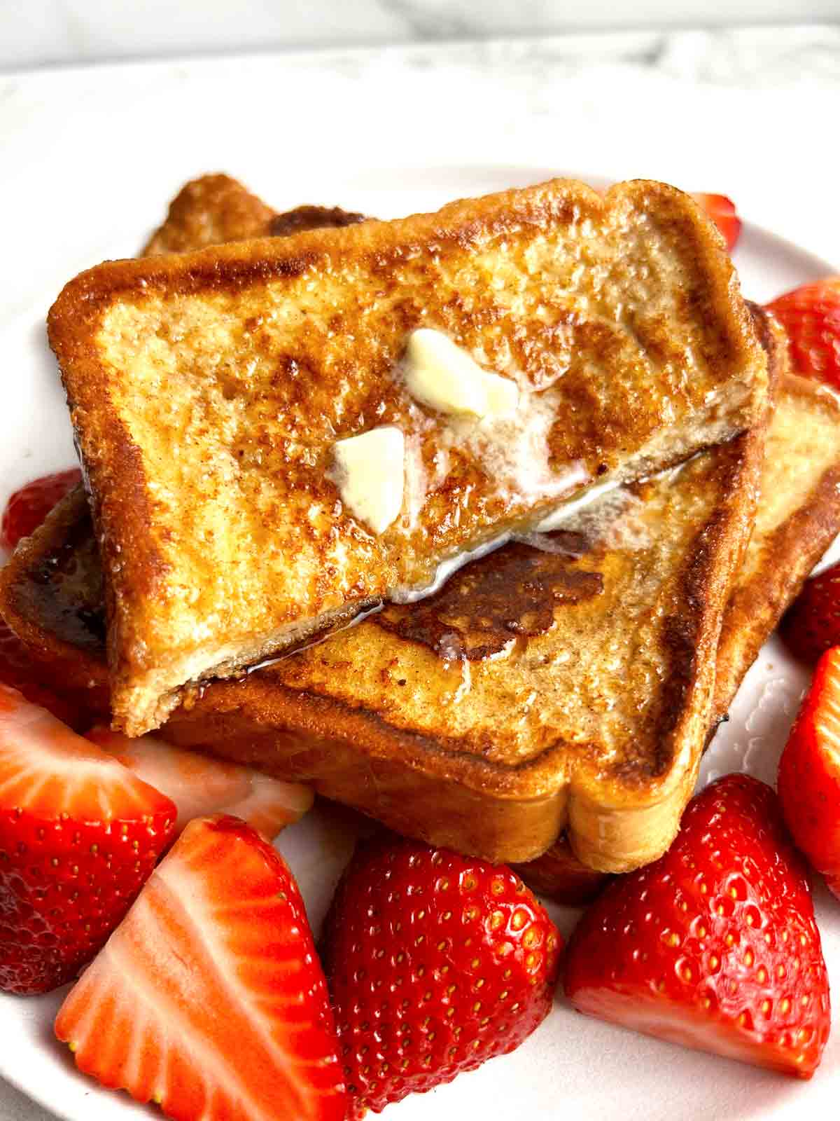 close up of French toast sliced in half.