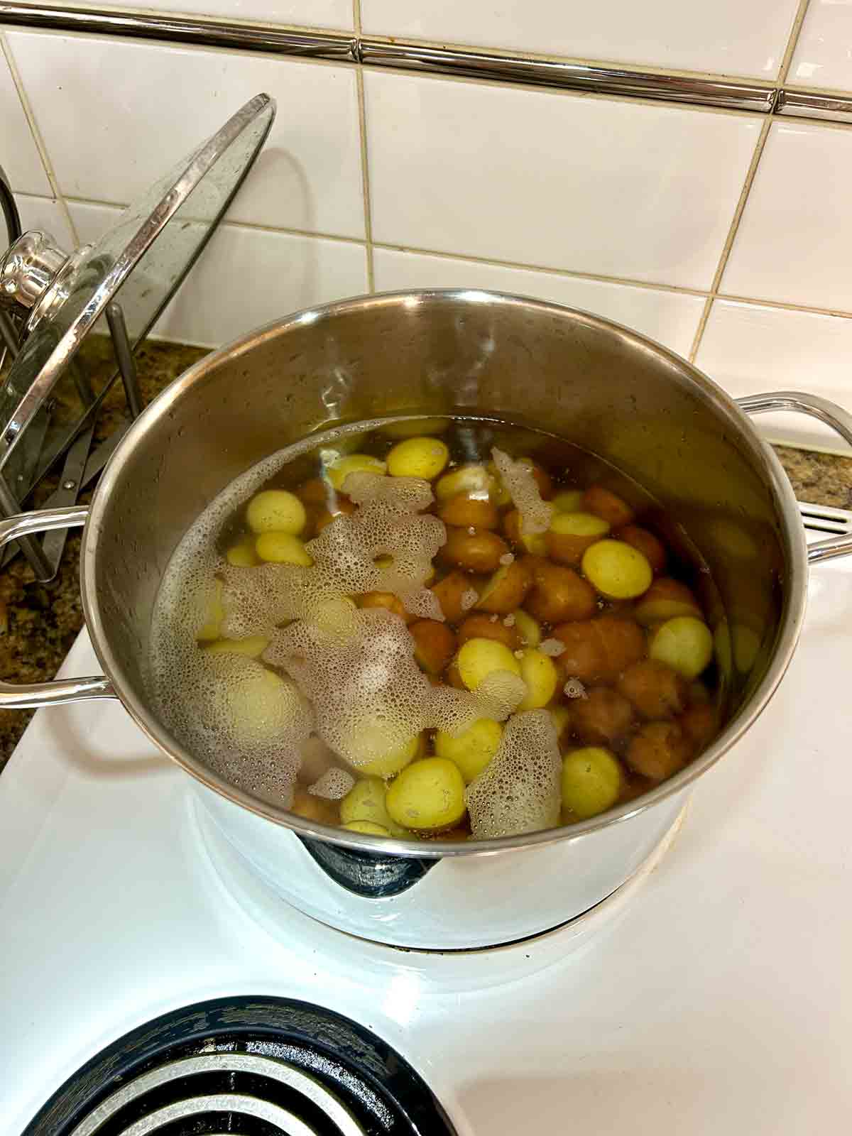 potatoes boiling in pot of water.