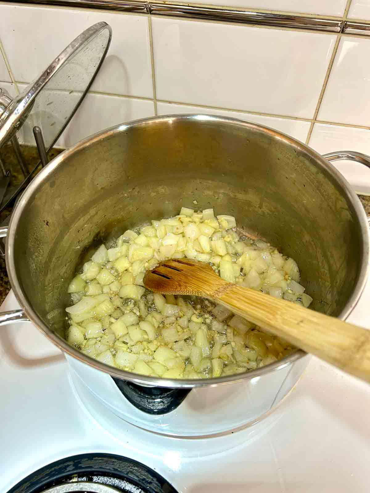 onions and garlic being sautéed in pot.