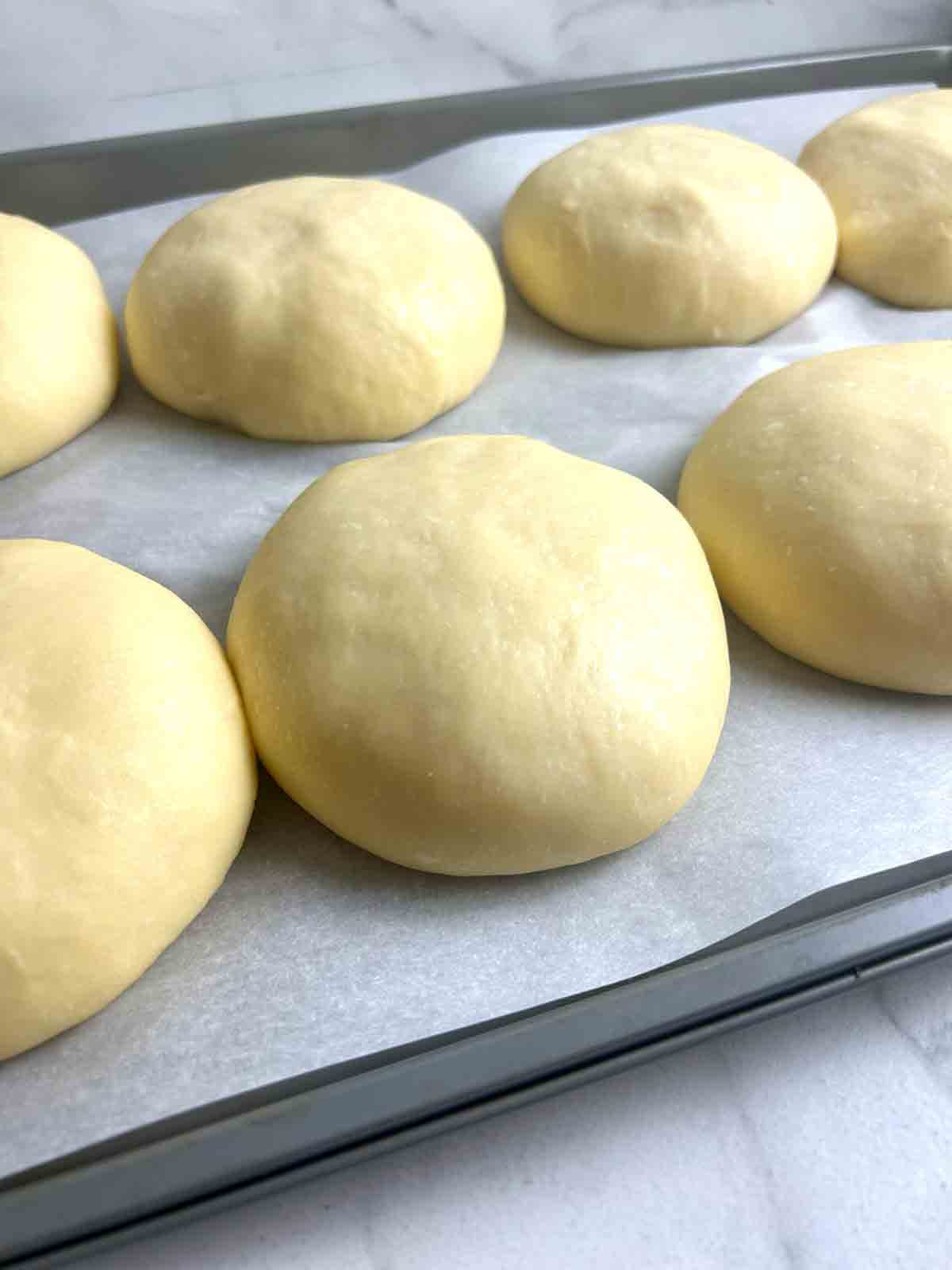 close up of dough balls after rising.