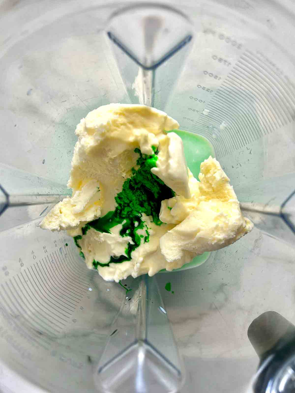 ice cream, food coloring, milk, and peppermint extract in blender.