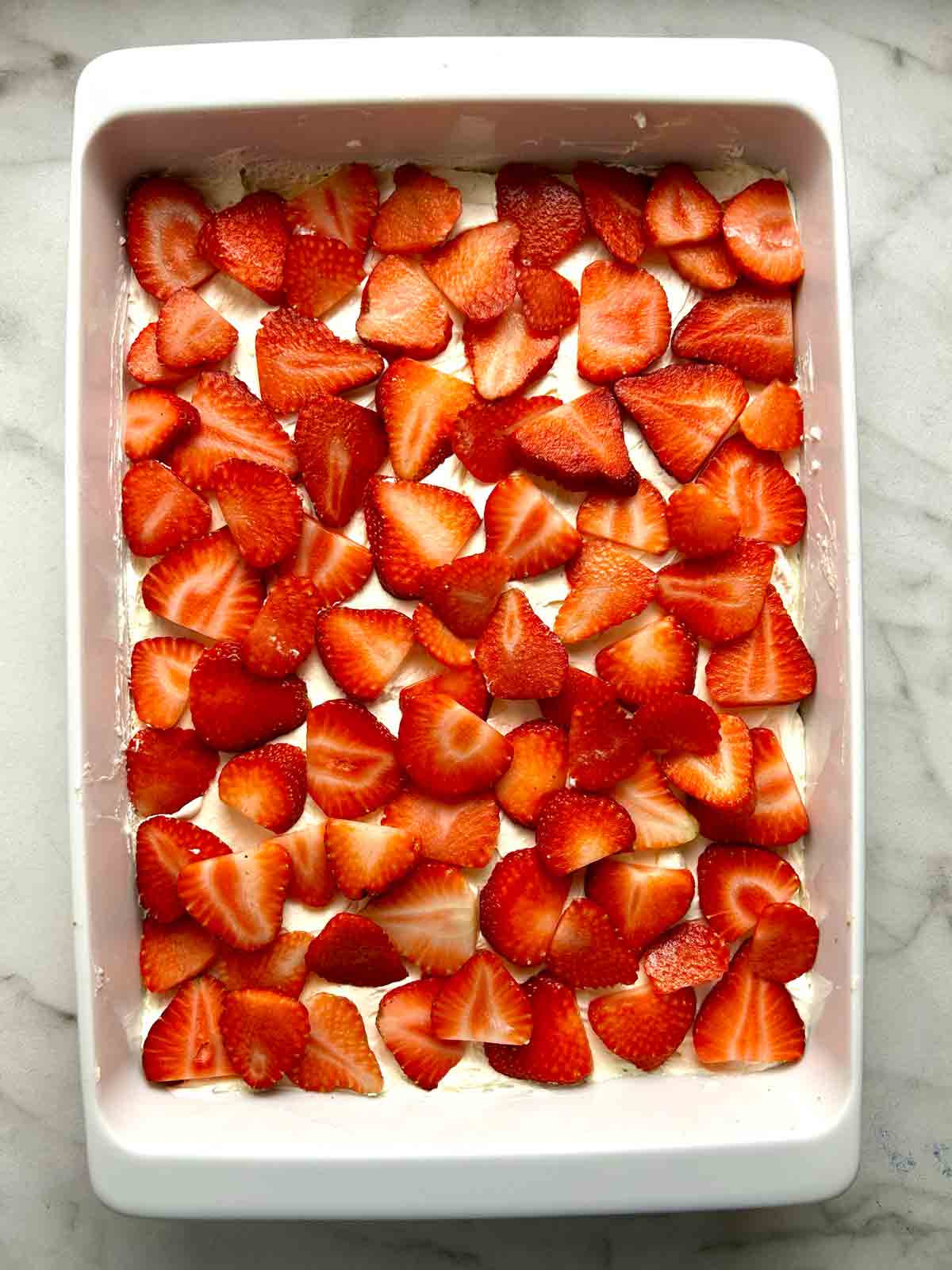 strawberries added on top of cream layer.