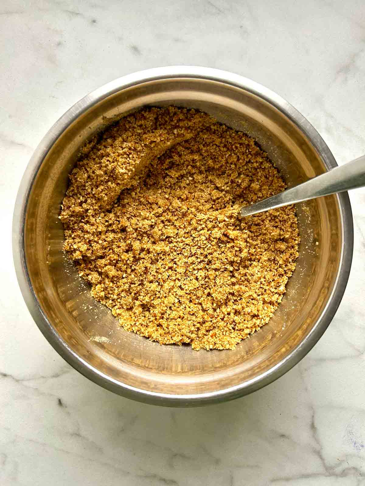 crushed pretzels mixed with butter and sugar in bowl.