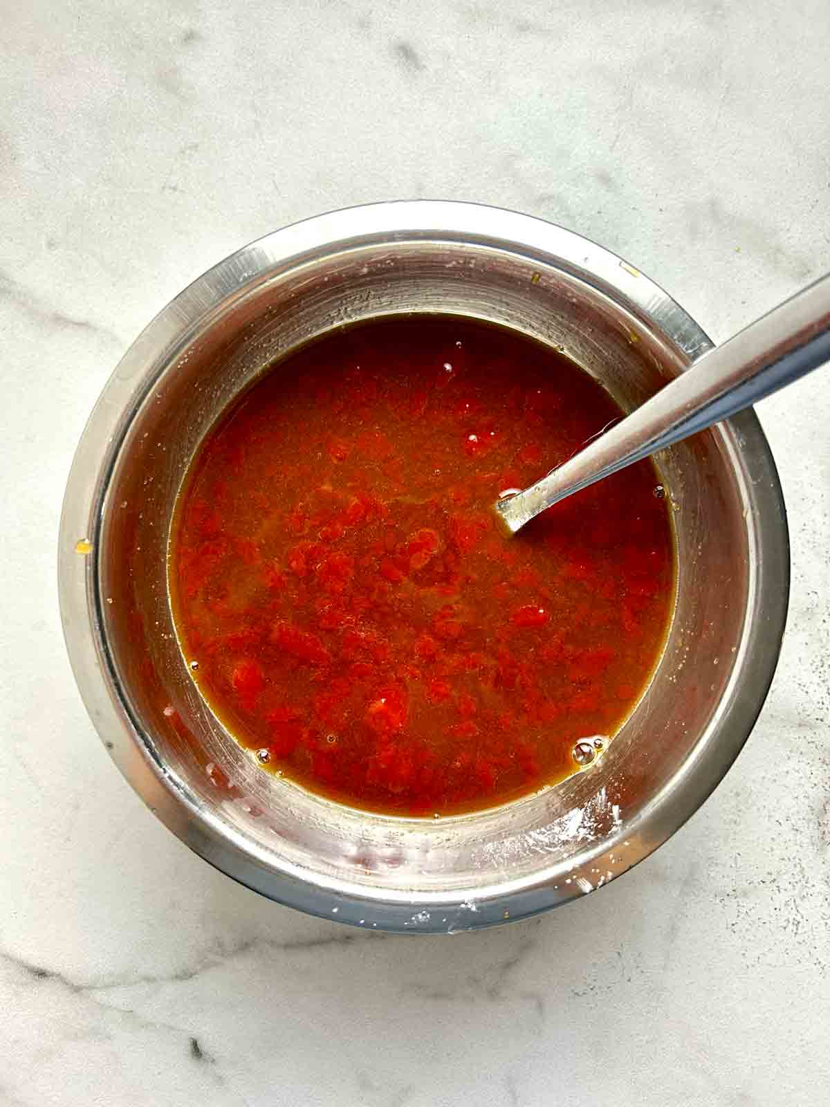 sweet and sour sauce mixed in bowl.