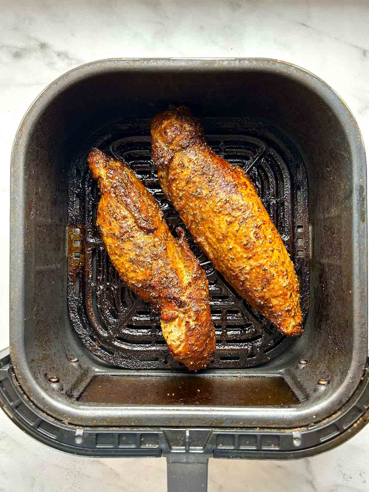 pork tenderloins after air-frying; crust on outside and golden brown.