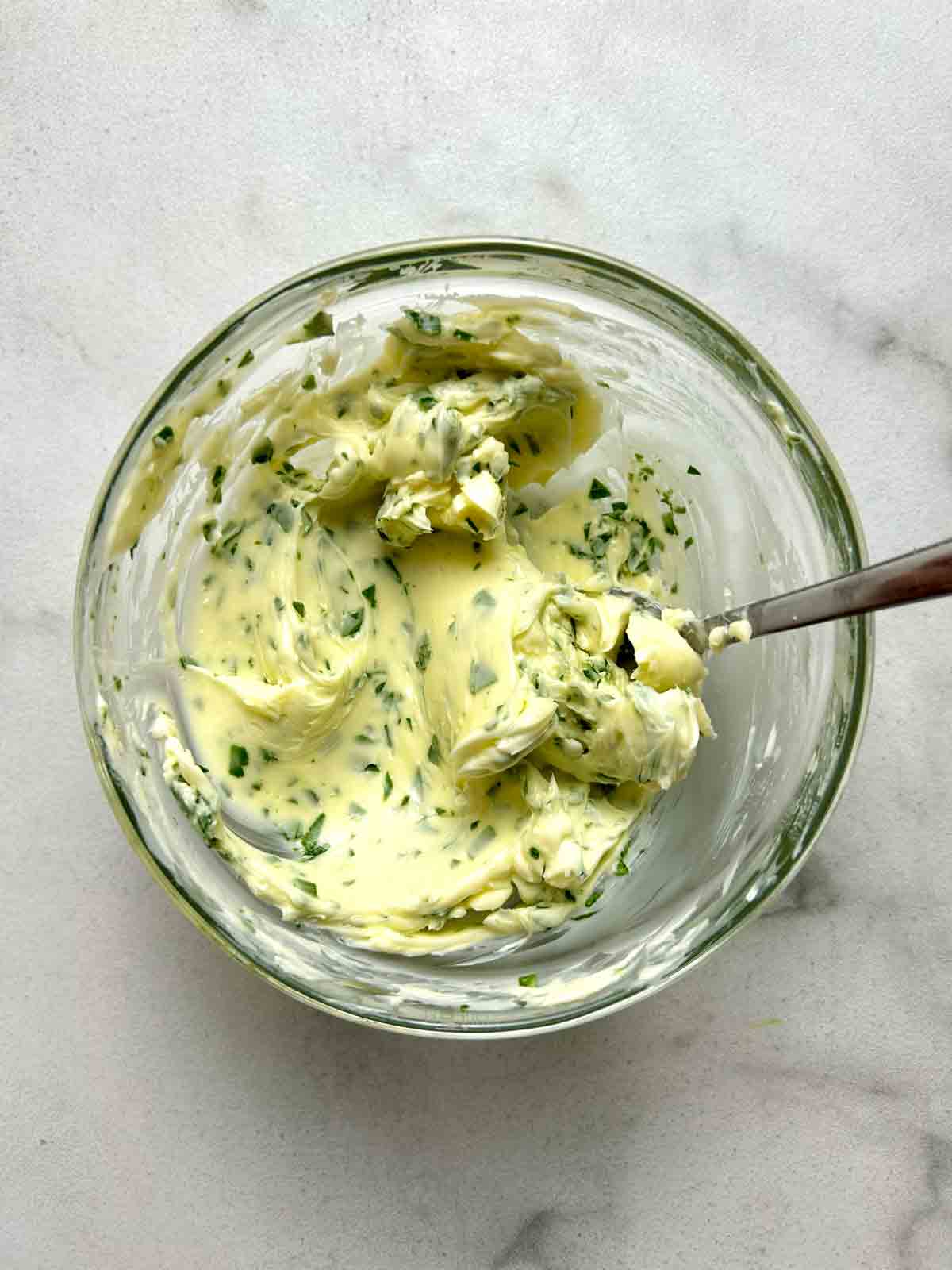 garlic butter mixture stirred together in small glass bowl.