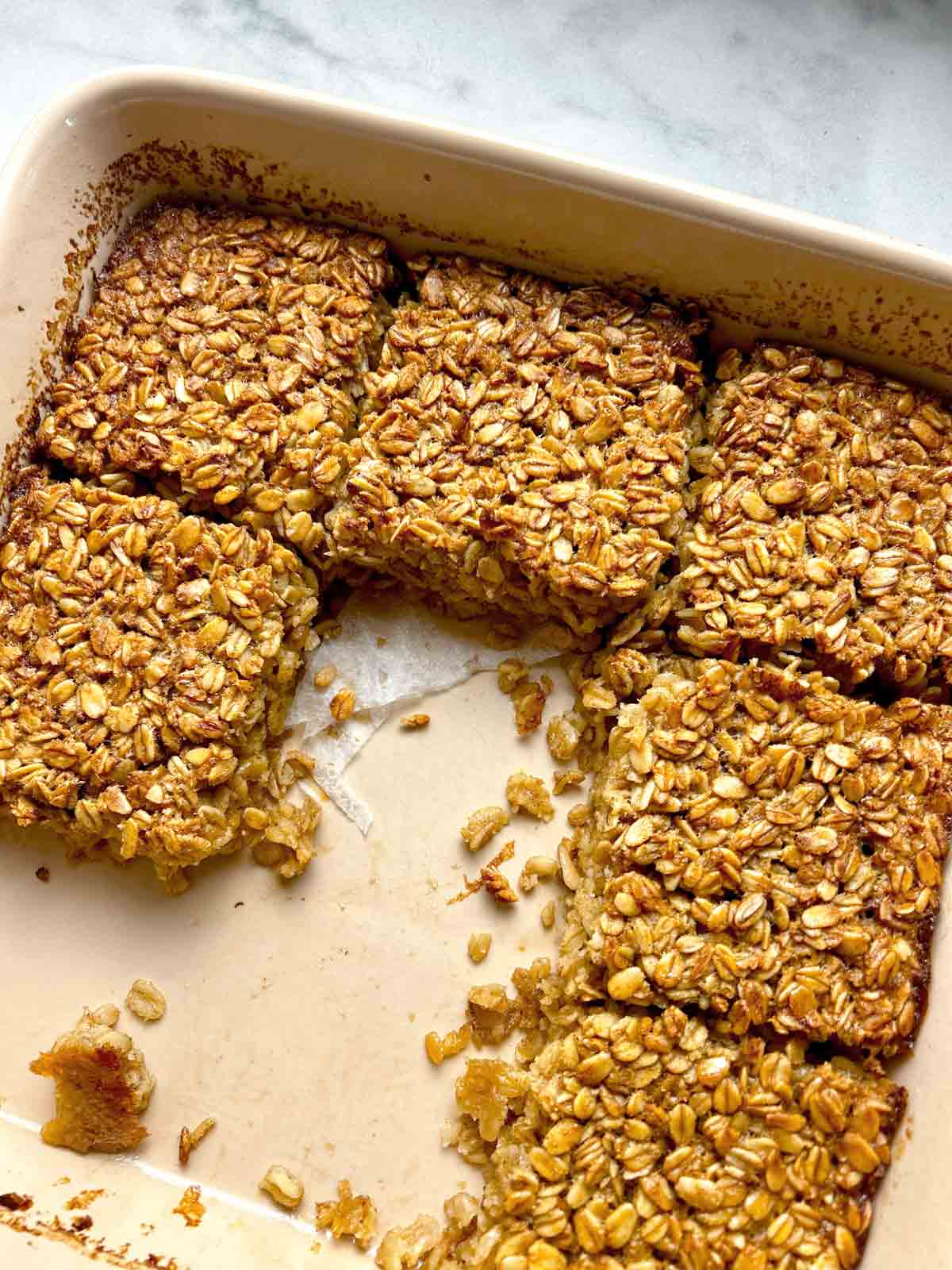 close up of baked oatmeal in baking dish.