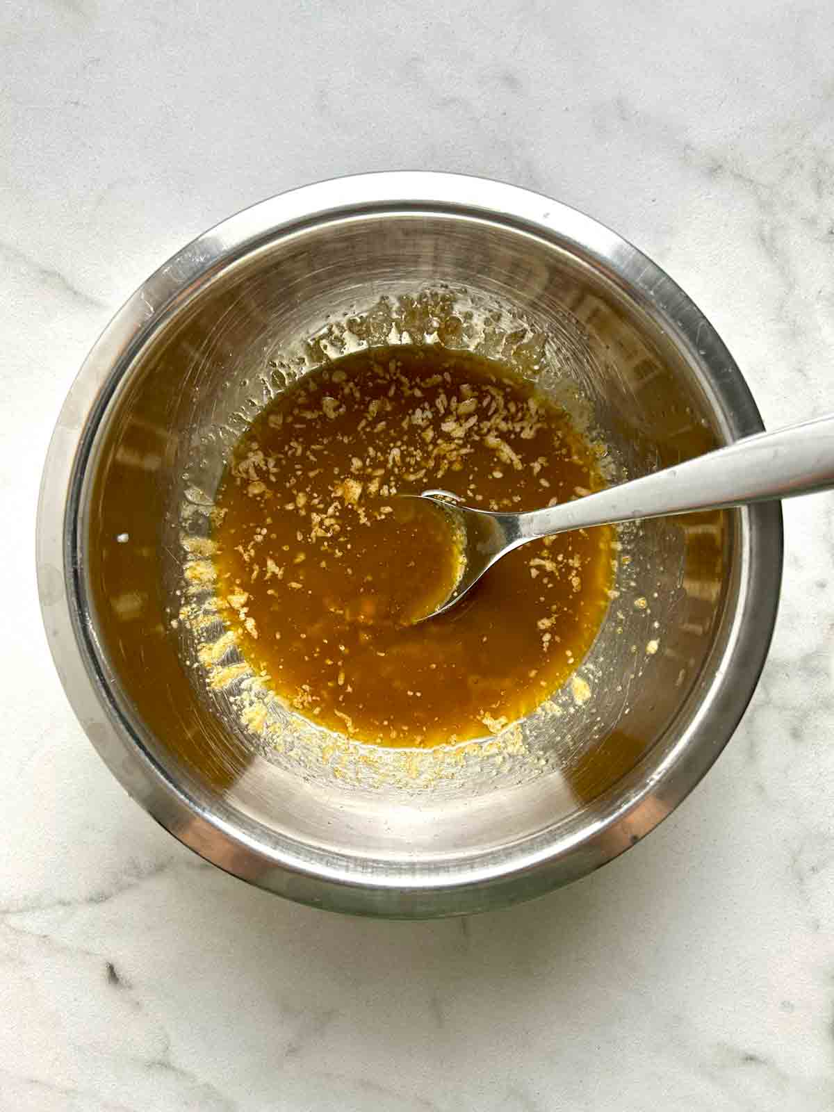 butter, Worcestershire sauce, and seasonings mixed in bowl.