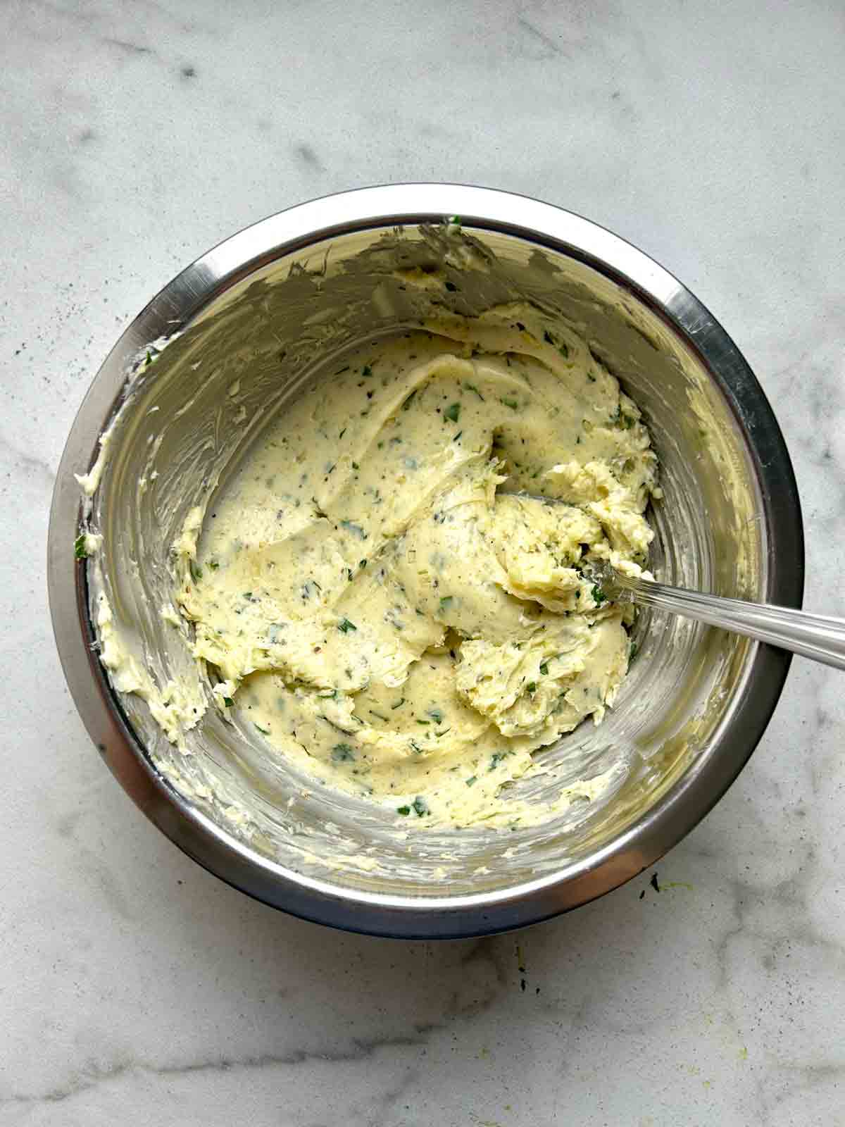 butter mixed with other ingredients in bowl.