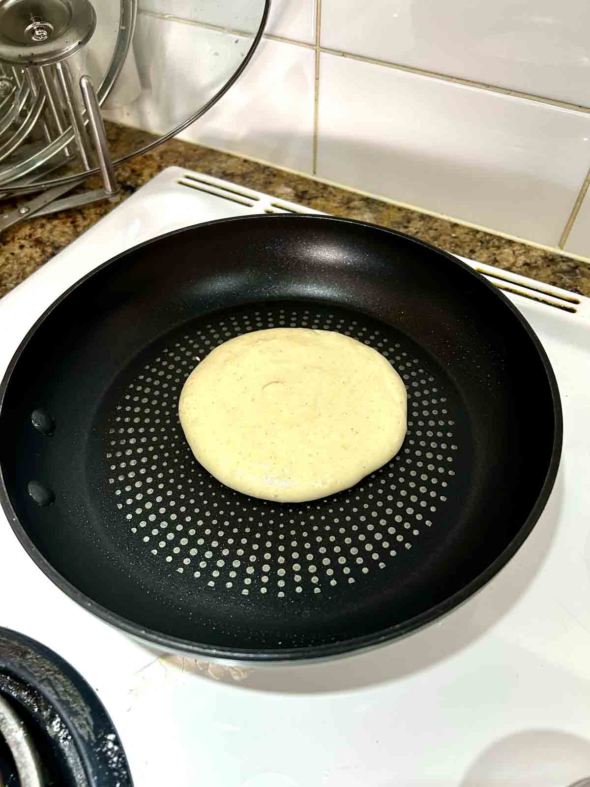 pancake batter scooped into nonstick pan.