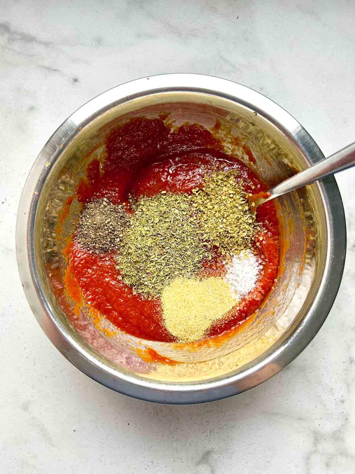 spices added on top of tomato paste.