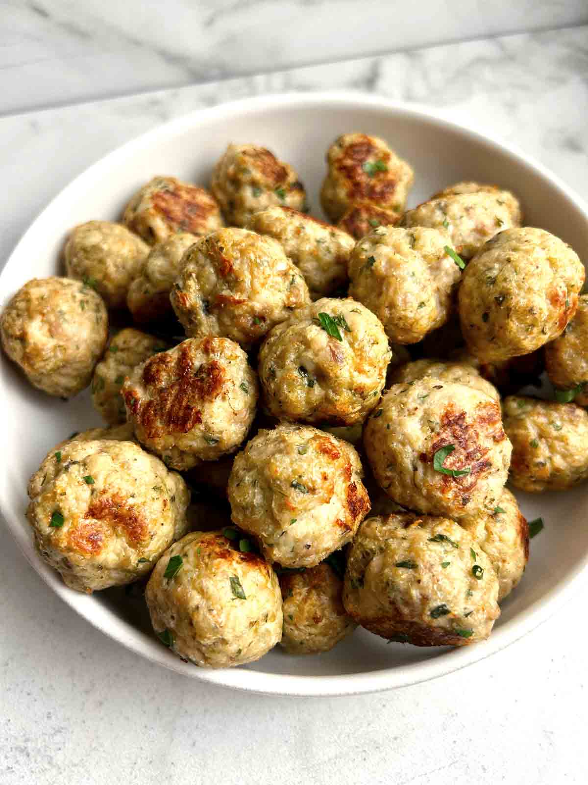 close up of turkey meatballs in bowl.