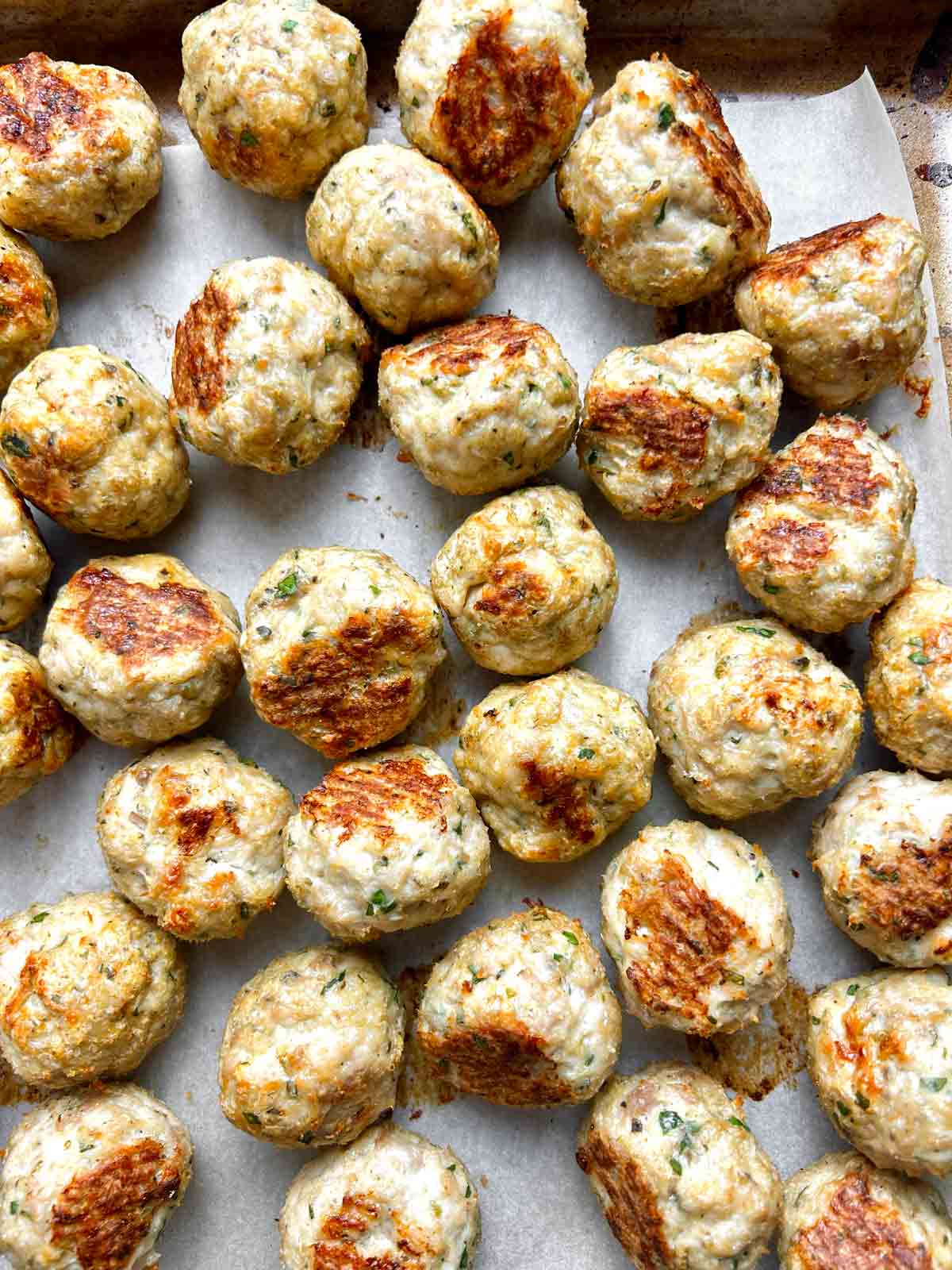 turkey meatballs on baking sheet.
