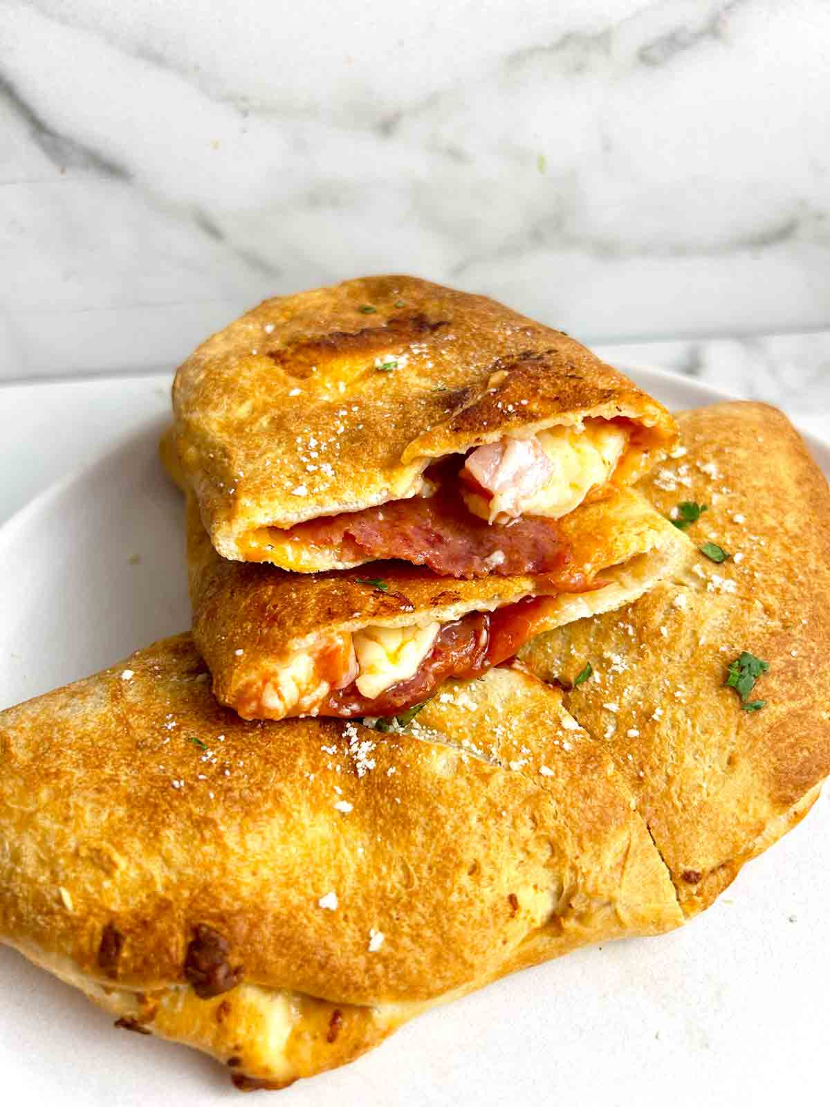 air fryer calzone cut in half to show inside.