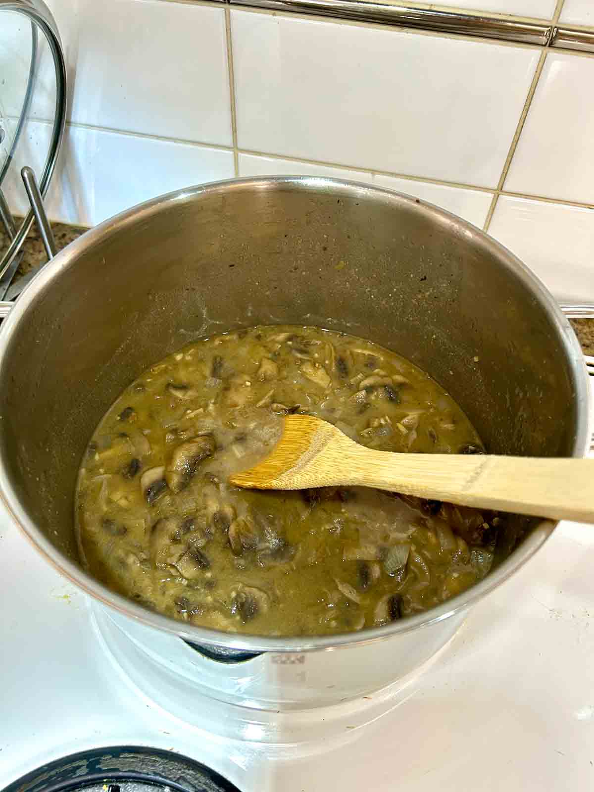 beef broth, mustard, and Worcestershire stirred into mushroom mixture.