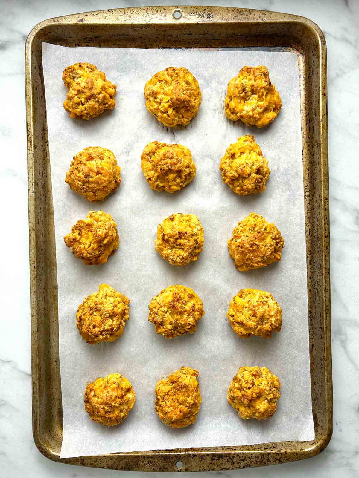 sausage balls after baking; golden brown and slightly spread out.