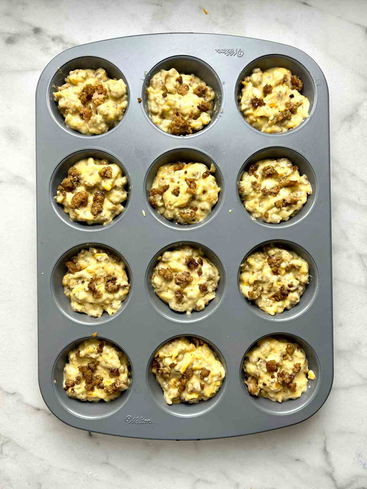 batter divided into muffin pan.