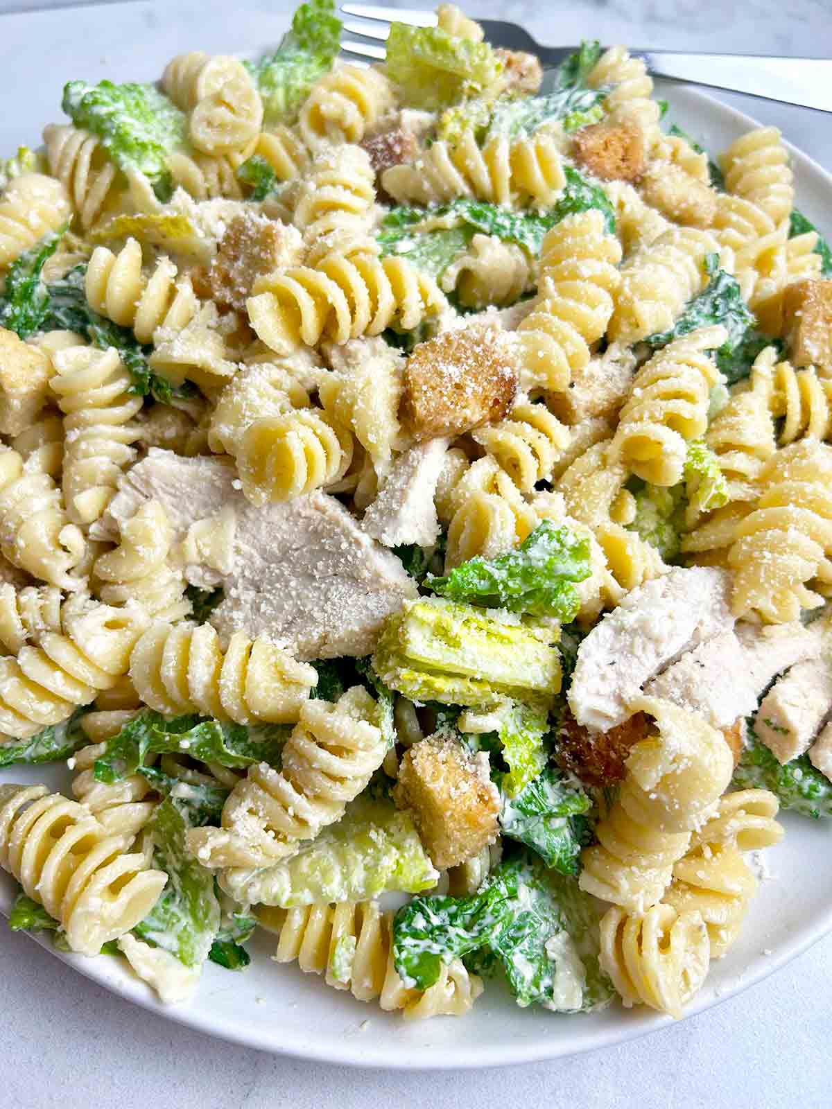 chicken caesar pasta salad on plate.