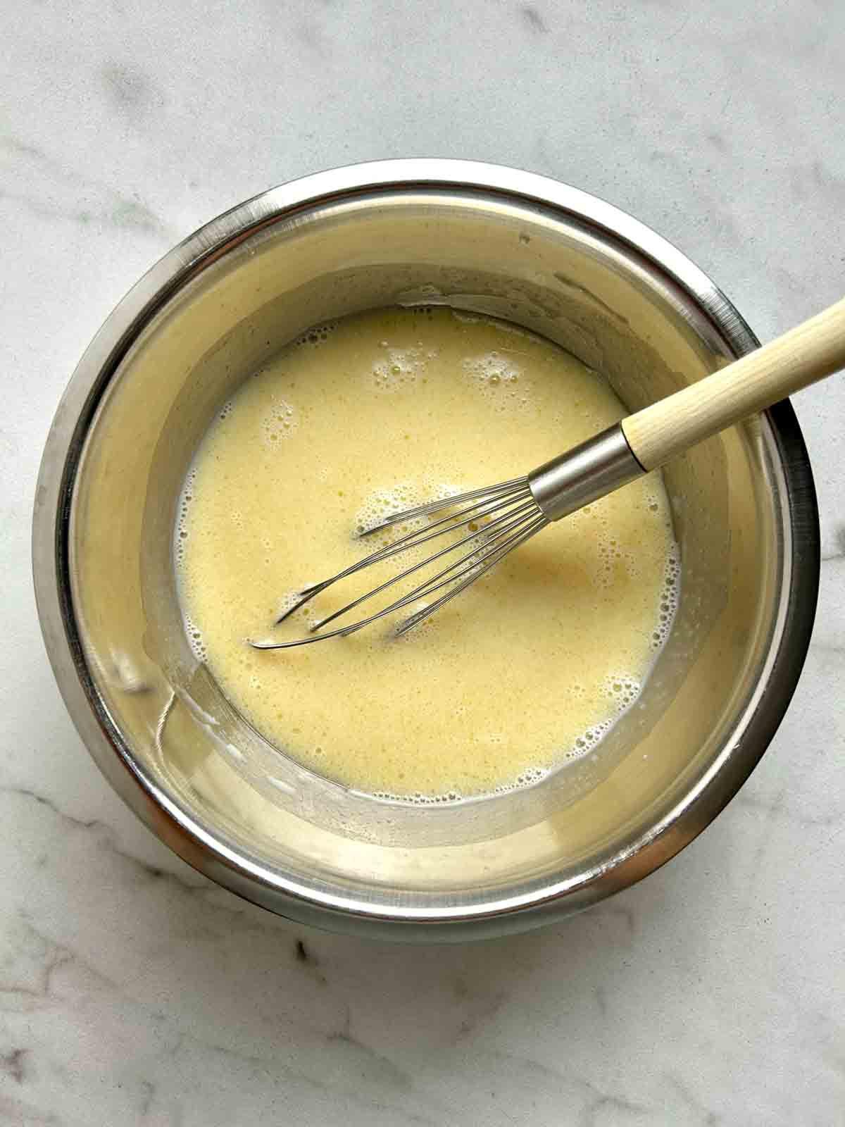 wet ingredients whisked in bowl.