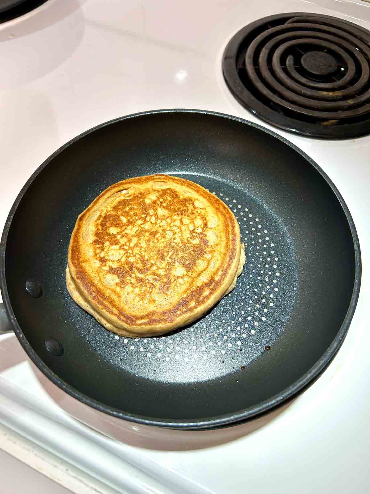 pancake after flipping; golden brown on bottom.