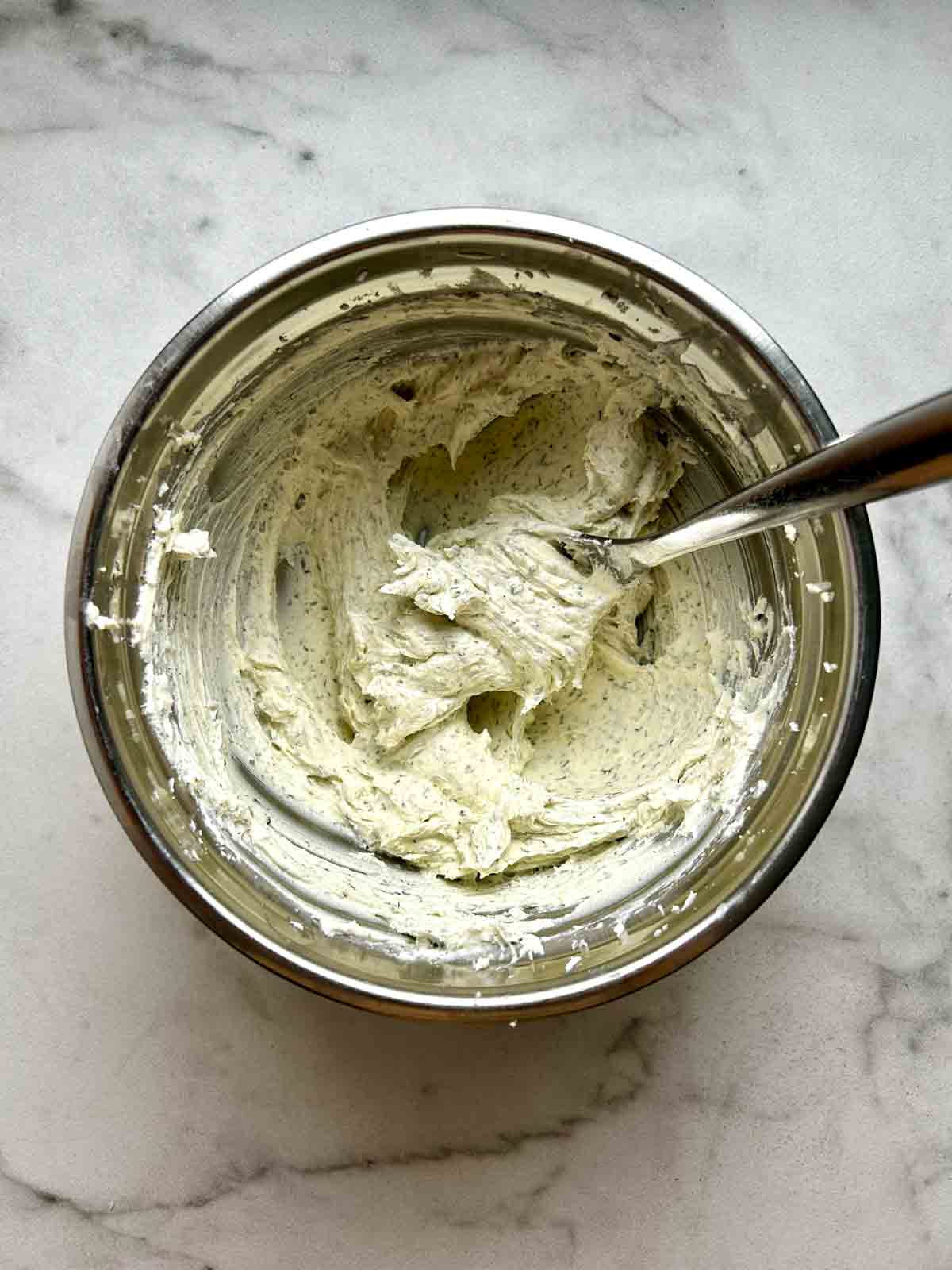 cream cheese mixture mixed with seasonings in bowl.