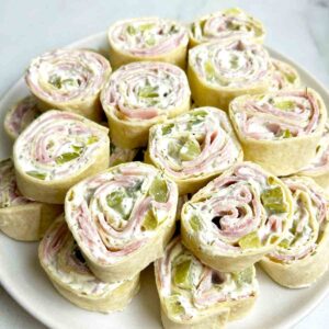 stack of dill pickle pinwheels on plate.