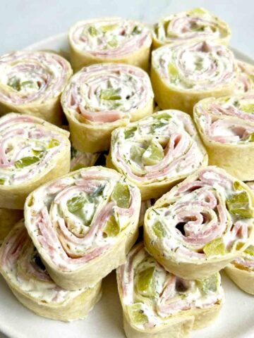 stack of dill pickle pinwheels on plate.