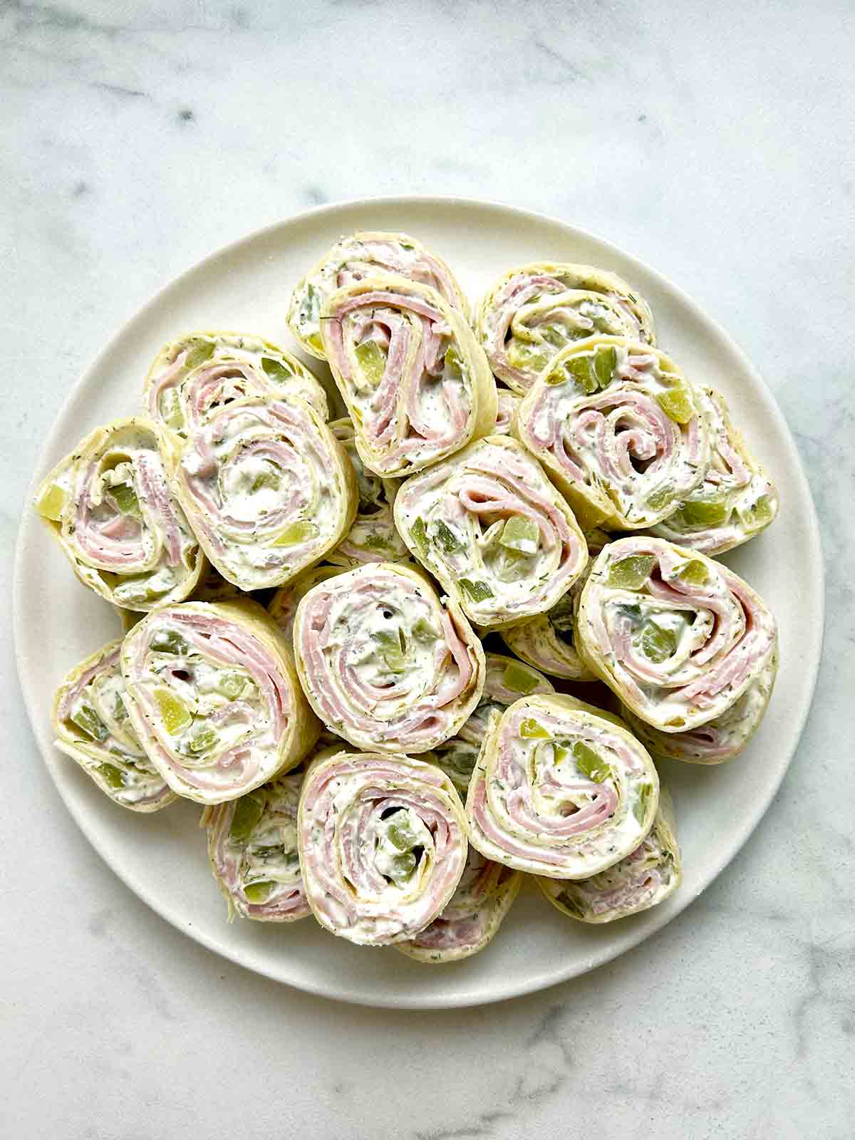 stack of dill pickle pinwheels on plate.