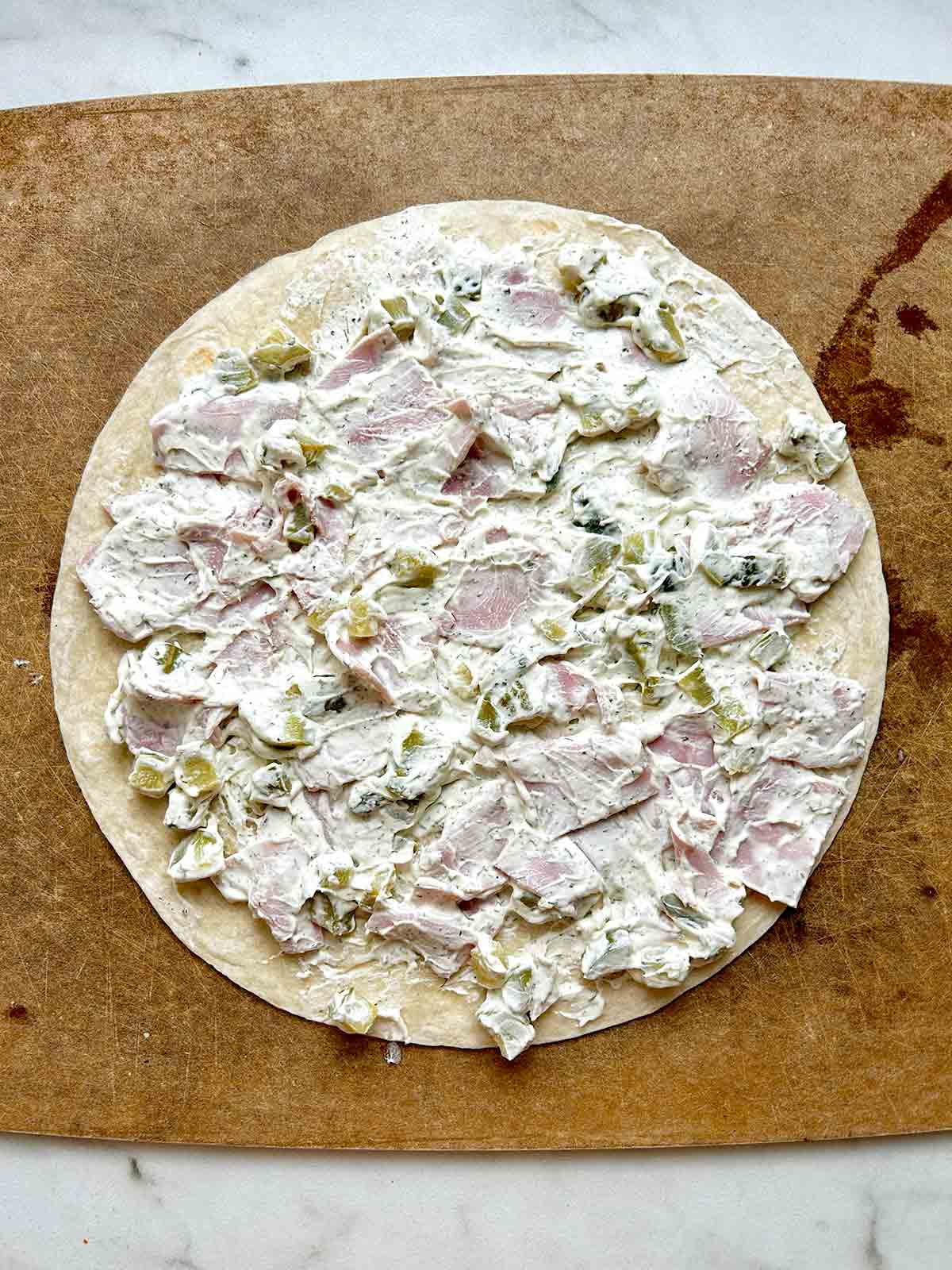 filling spread onto flour tortilla.