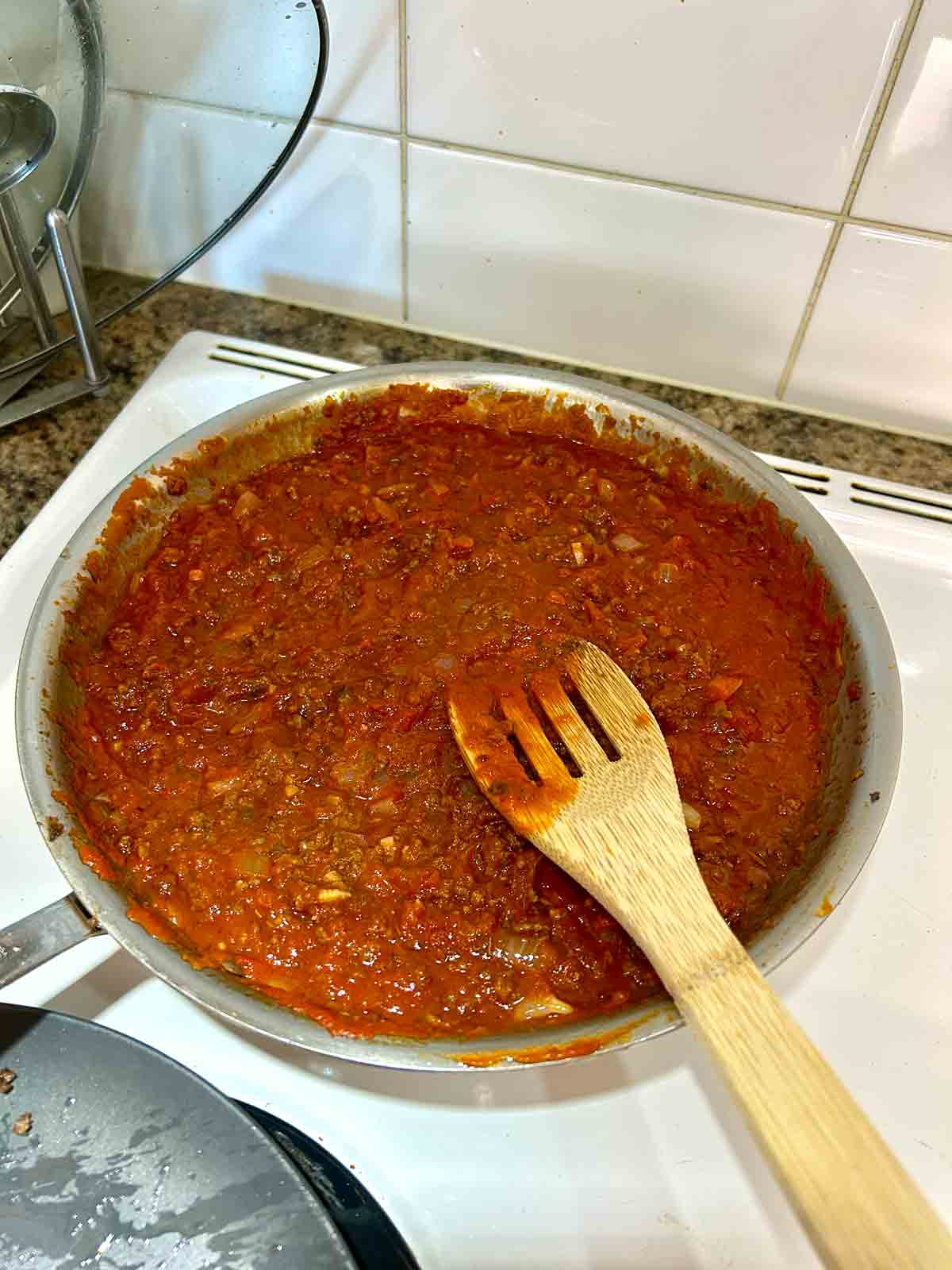 marinara sauce adding to beef and onion mixture.