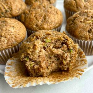 close up of zucchini muffin with bite taken out of it.
